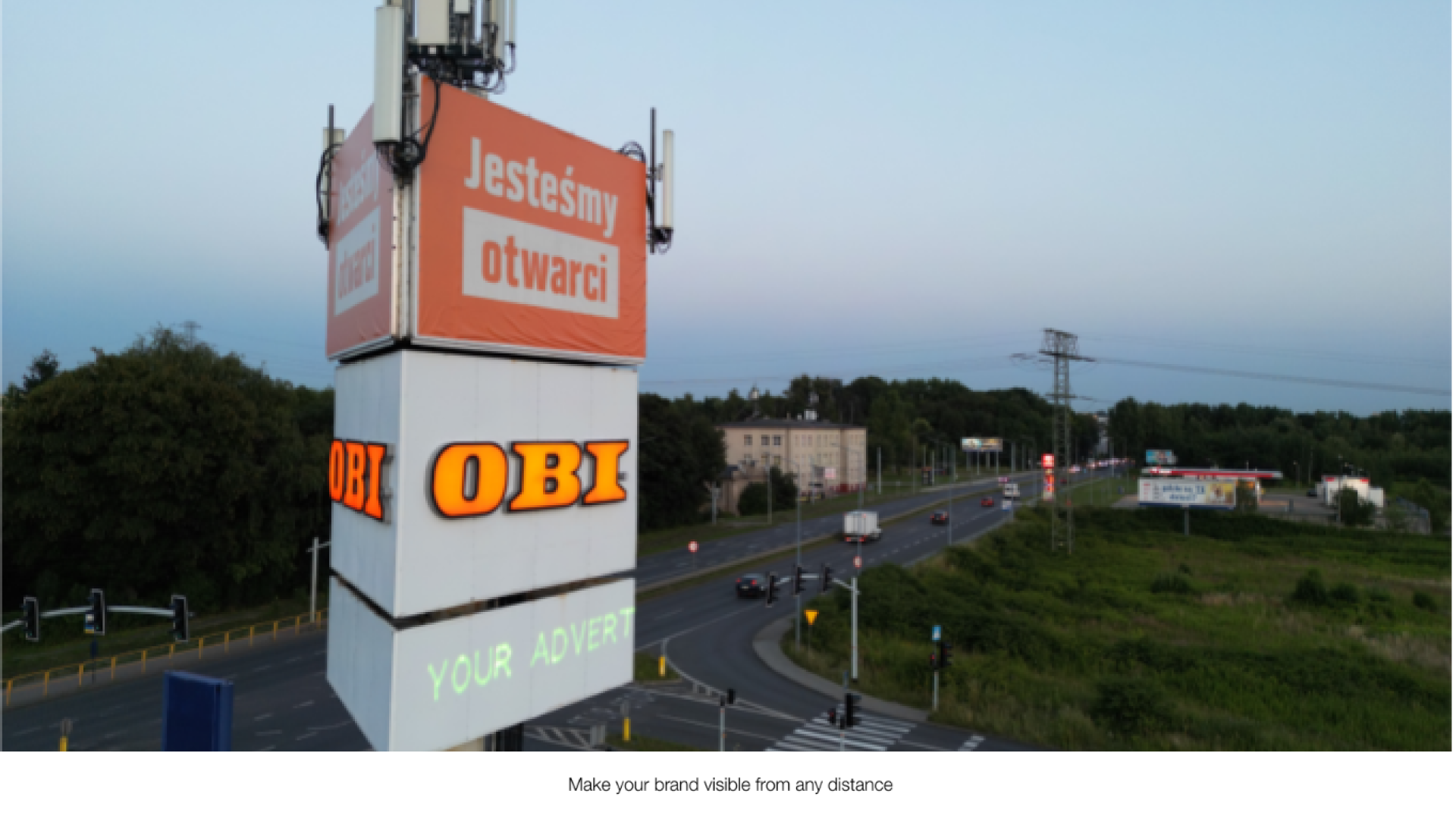 obi2 A large signage outdoor with the text "your advert" projected onto it from a Lasercube laser projector, showcasing how it can be used for outdoor advertising