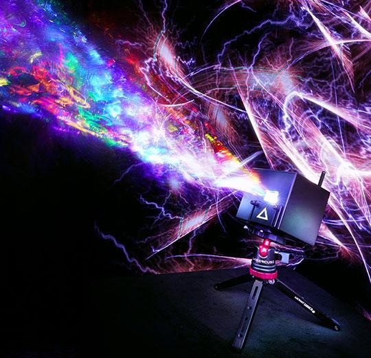 Picture of lasercube laser projector with lights projecting upwards, while on the floor.