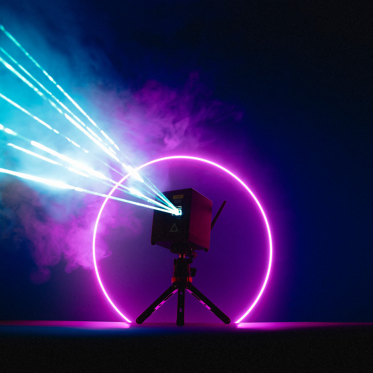wifi-new-4 Lasercube with purple strobe light circle projecting lasers in a dark environment.